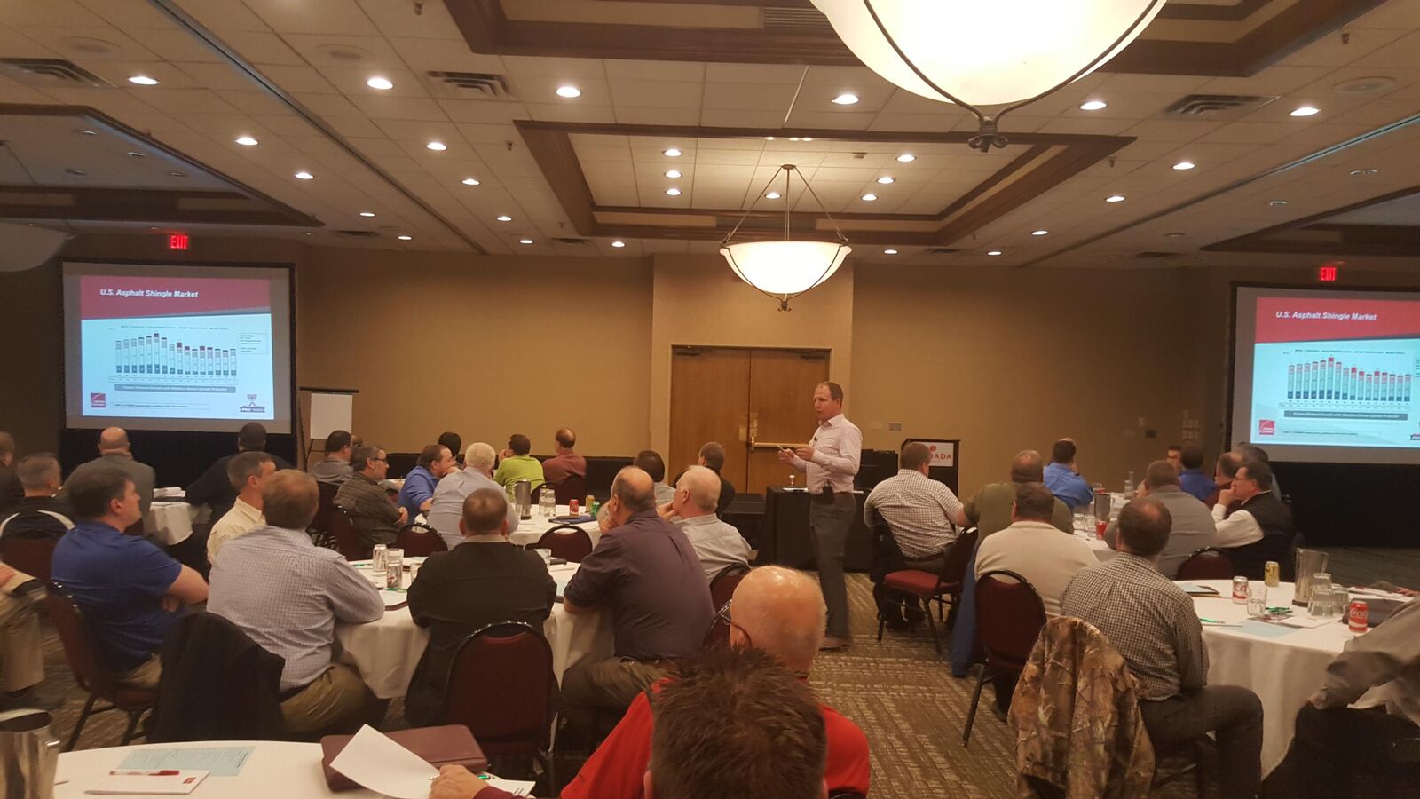 Chris Morris presenting U.S. asphalt shingle market data to a room of contractors